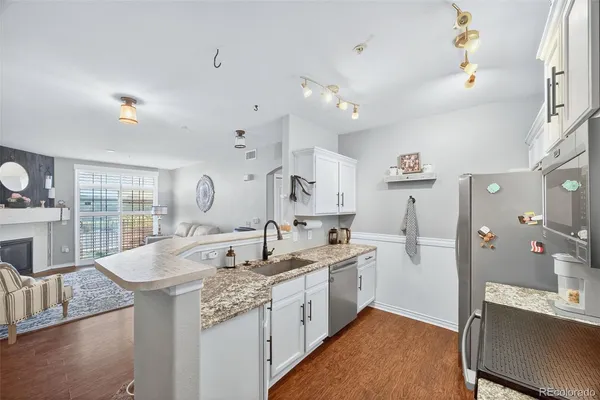 a large white kitchen with a large window
