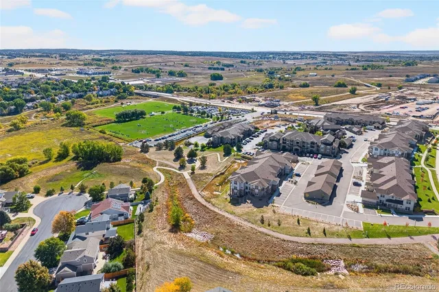 an aerial view of a residential houses with outdoor space