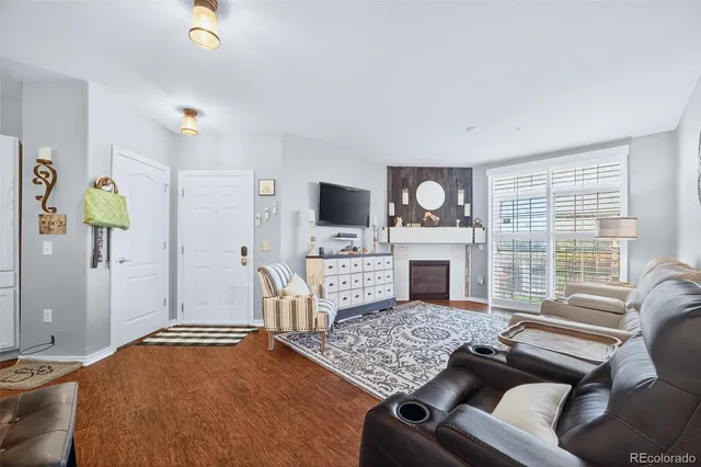 a living room with a fireplace furniture and a flat screen tv