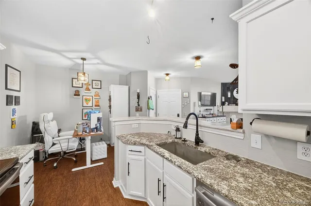 a kitchen with sink and cabinets