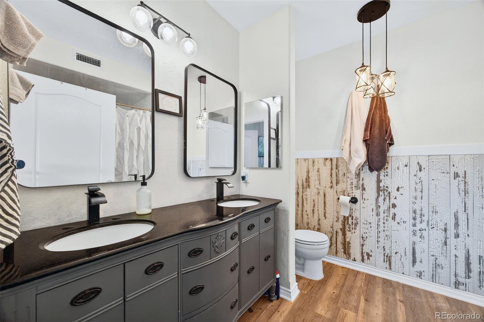 18669 Stroh Road, Unit 10005 Parker, CO 80134 - Photo 9 of 18 a bathroom with a double vanity sink mirror and shower