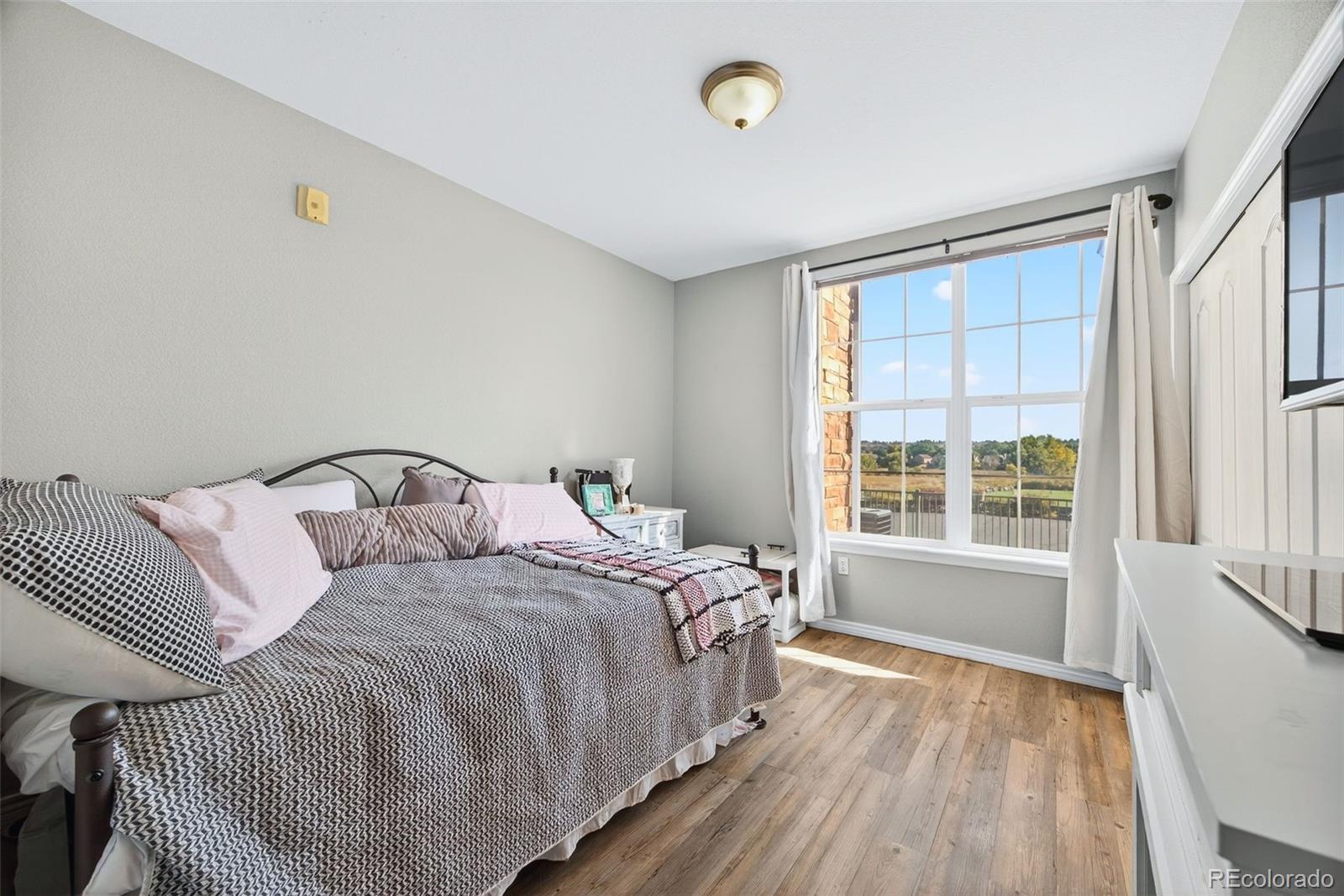 18669 Stroh Road, Unit 10005 Parker, CO 80134 - Photo 10 of 18 a bedroom with a bed and a window