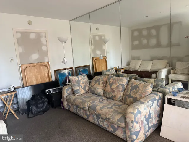 a bed room with a bed and mirror