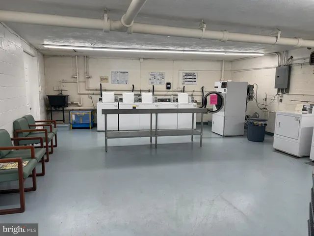 a view of walk in closet with clothes