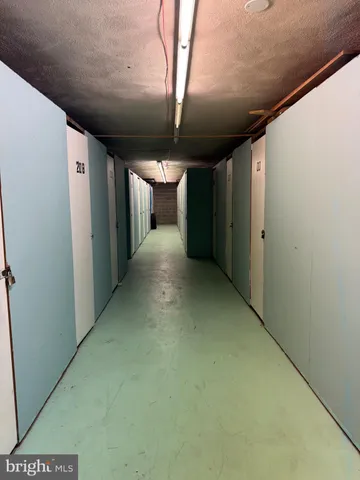 a view of pool with umbrella and trees