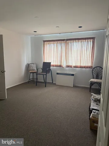 a bedroom with a bed chair and window