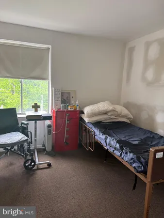 a bathroom with a granite countertop shower a toilet and a sink