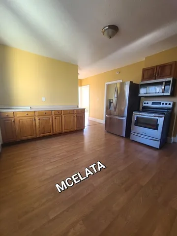 a view of kitchen with furniture and wooden floor