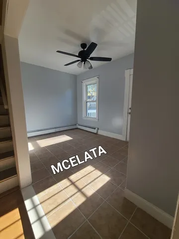 a view of a room with a window and wooden floor