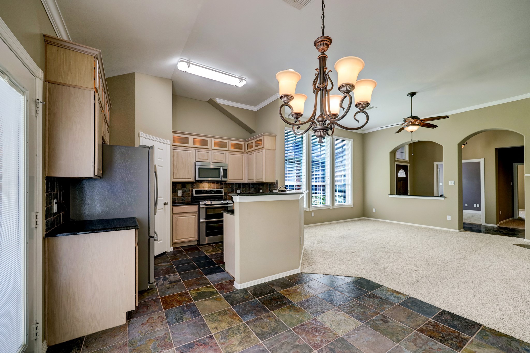 18618 Jaya Loch Court Spring, TX 77379 - Photo 8 of 18 a view of a kitchen with a sink and dishwasher a refrigerator with wooden floor