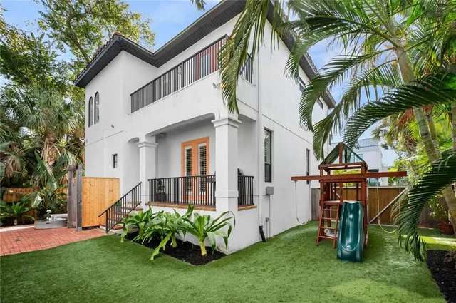 a front view of house with a garden