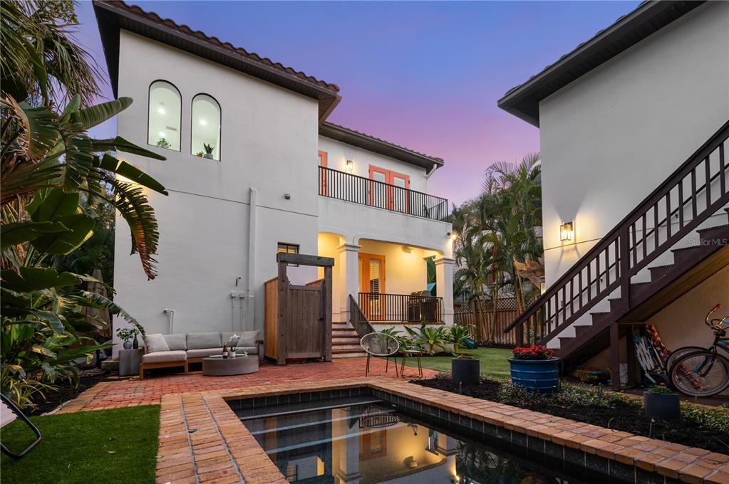 1723 Oak Street Sarasota, FL 34236 - Photo 19 of 34 a front view of house and yard with beautiful flowers and wooden fence