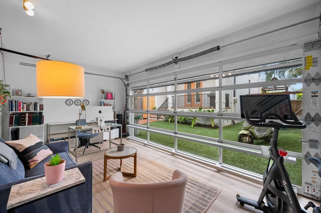 1723 Oak Street Sarasota, FL 34236 - Photo 25 of 34 a living room with furniture a flat screen tv and a floor to ceiling window