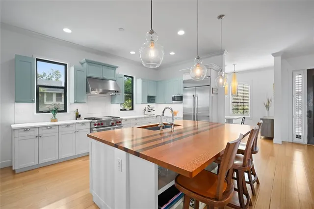 a large kitchen with a table and chairs