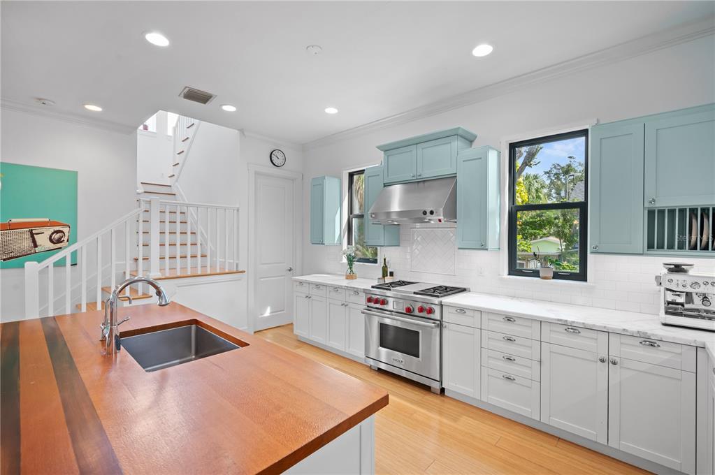 1723 Oak Street Sarasota, FL 34236 - Photo 4 of 34 a kitchen with stainless steel appliances kitchen island granite countertop a sink stove and cabinets