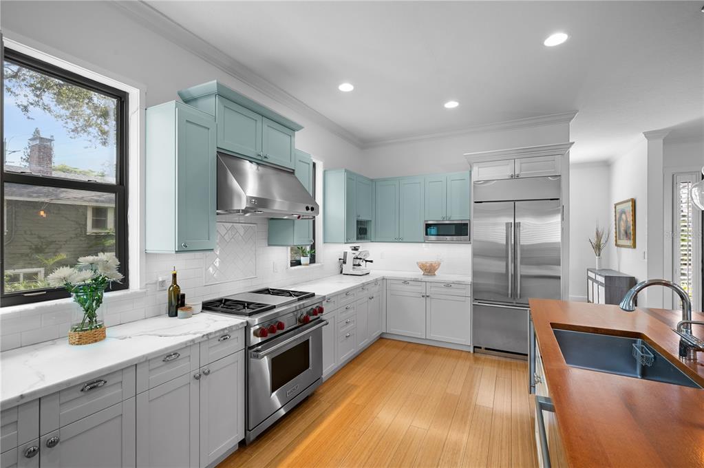 1723 Oak Street Sarasota, FL 34236 - Photo 5 of 34 a kitchen that has a lot of cabinets in it and wooden floors