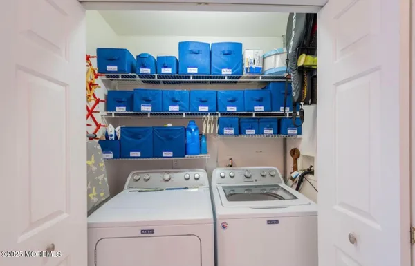 a view of storage and utility room with washer and dryer