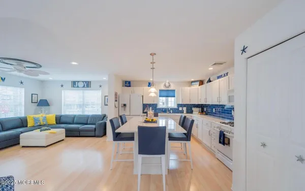 a living room with furniture and kitchen view