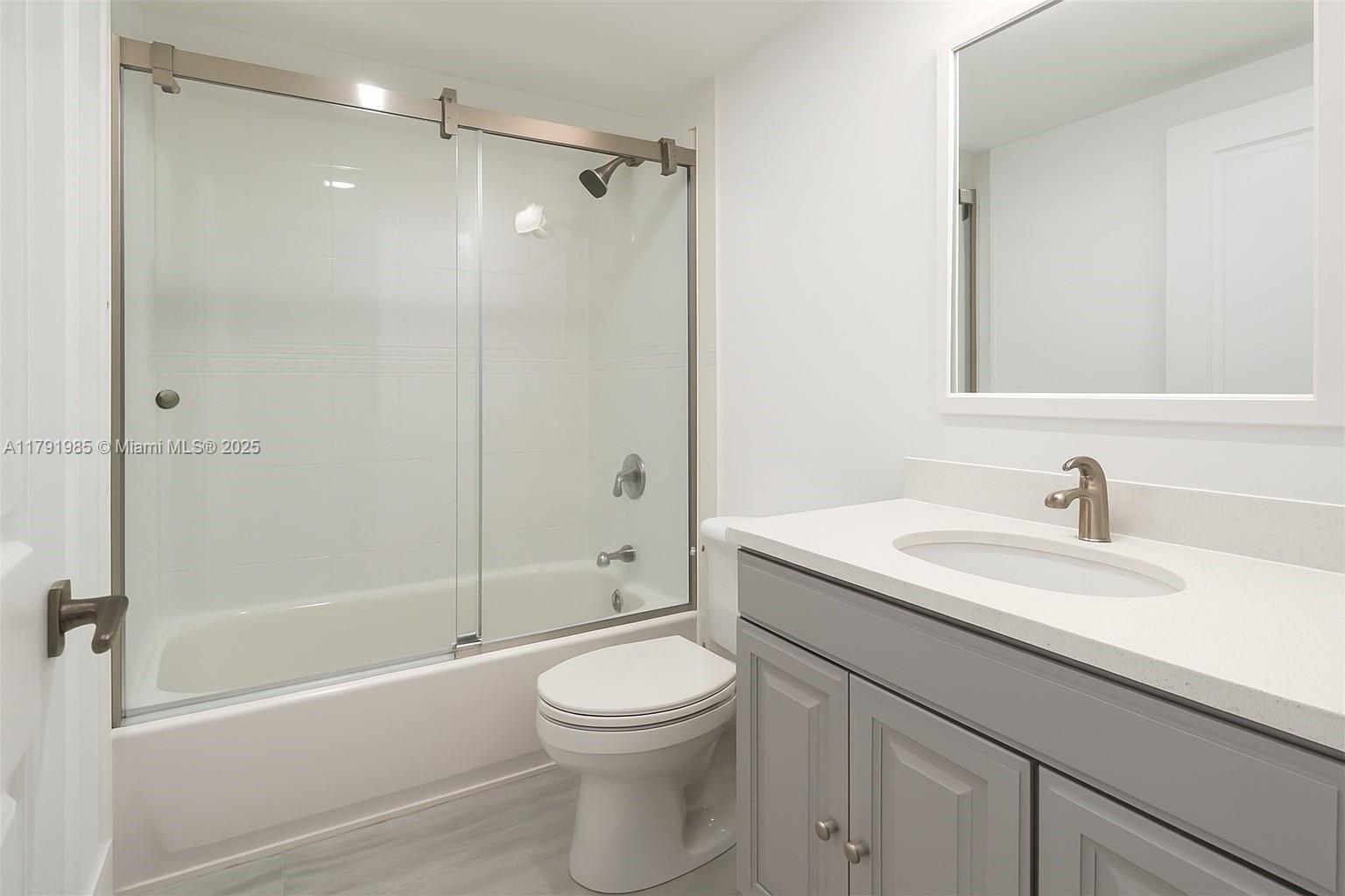 575 Crandon Boulevard, Unit 307 Key Biscayne, FL 33149 - Photo 16 of 37 a bathroom with a sink a toilet and shower