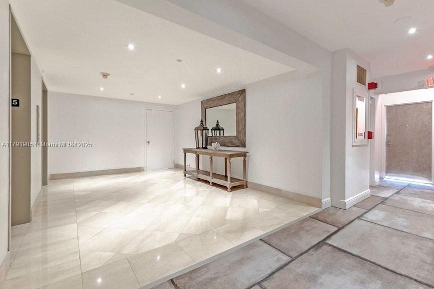 575 Crandon Boulevard, Unit 307 Key Biscayne, FL 33149 - Photo 20 of 37 a view of a hallway with cabinet and mirrors
