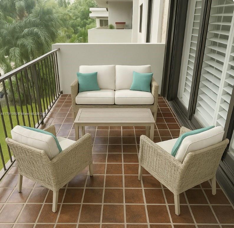 575 Crandon Boulevard, Unit 307 Key Biscayne, FL 33149 - Photo 22 of 37 a view of a chair and table in the balcony