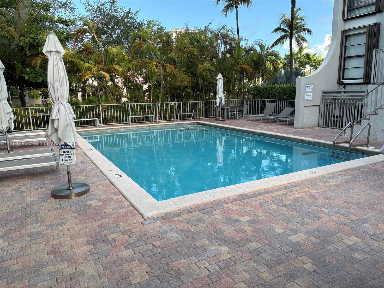 575 Crandon Boulevard, Unit 307 Key Biscayne, FL 33149 - Photo 32 of 37 a view of a swimming pool with a patio