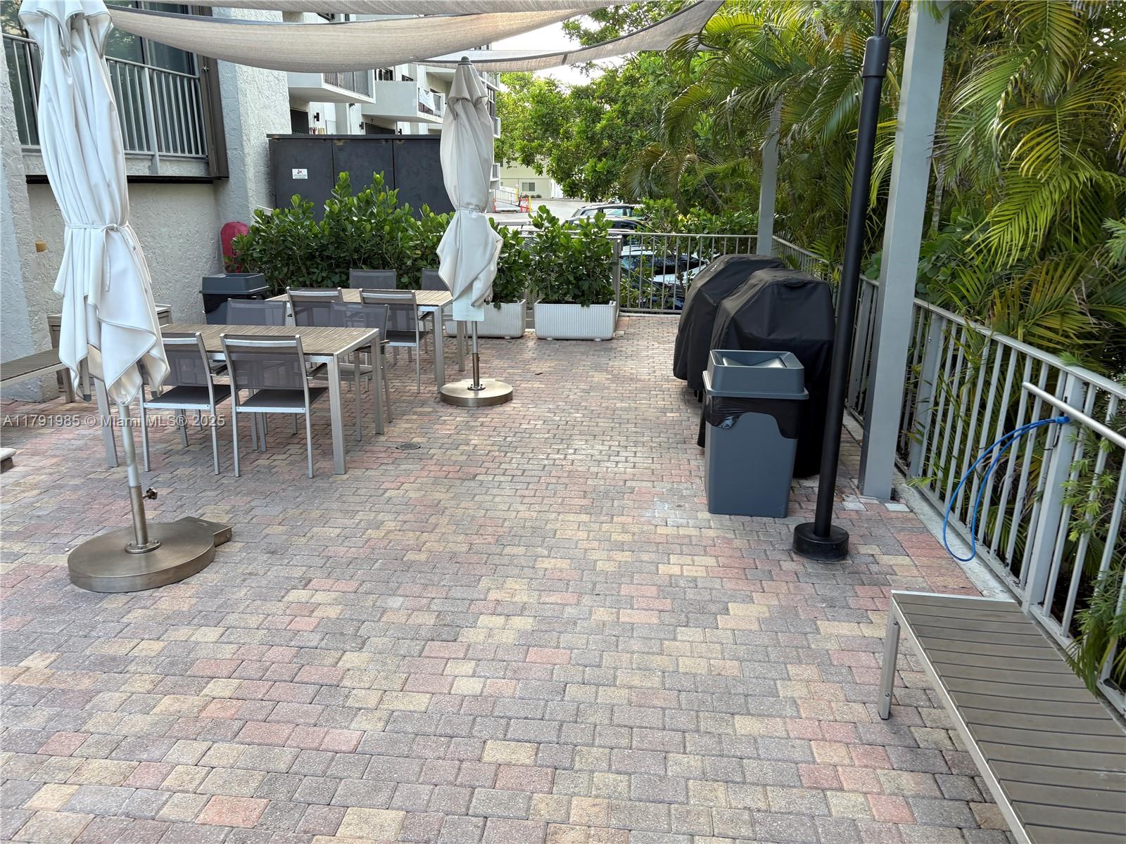 575 Crandon Boulevard, Unit 307 Key Biscayne, FL 33149 - Photo 33 of 37 a view of a chairs and tables in the patio