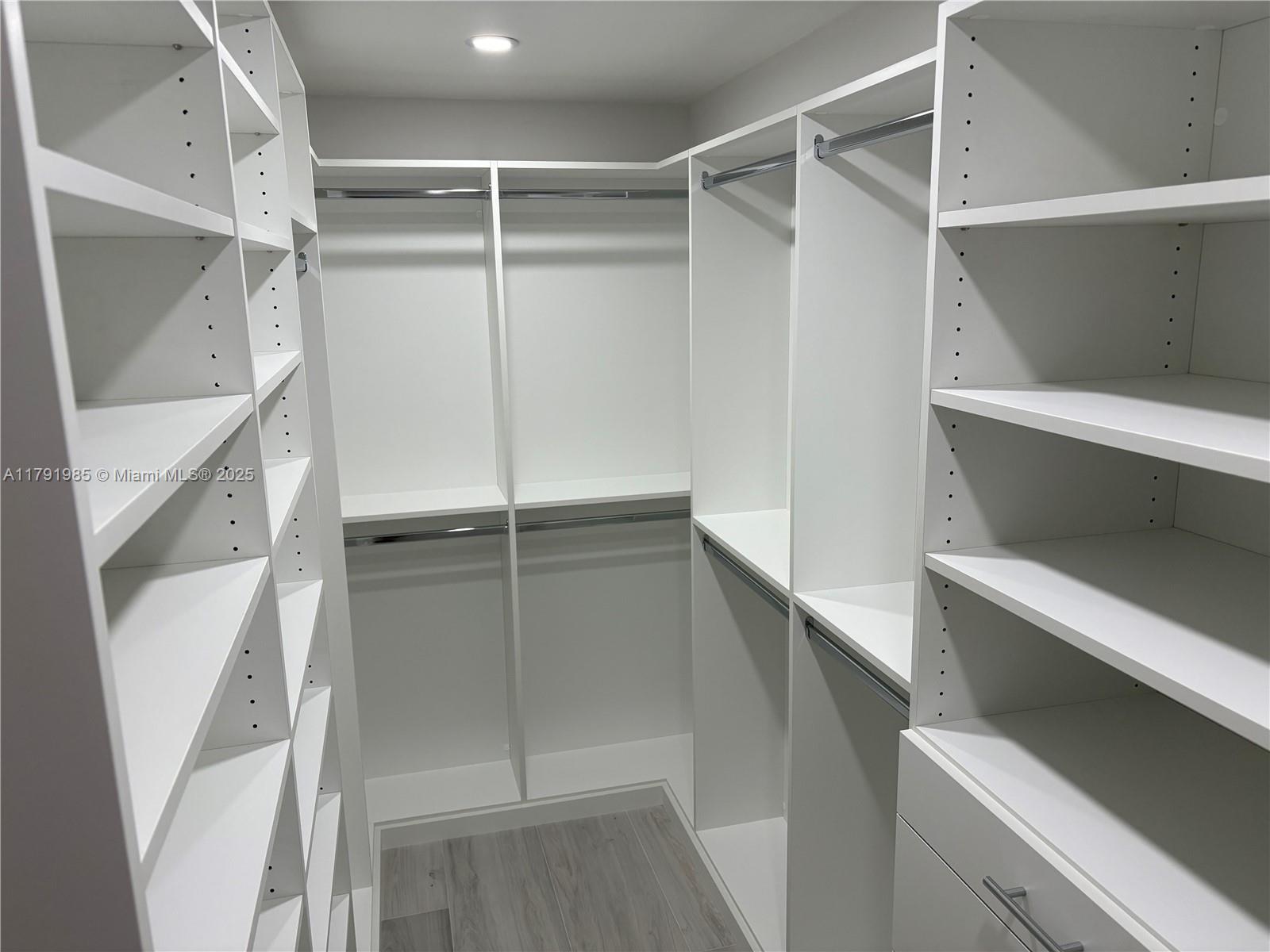 575 Crandon Boulevard, Unit 307 Key Biscayne, FL 33149 - Photo 10 of 37 a view of walk in closet with empty racks