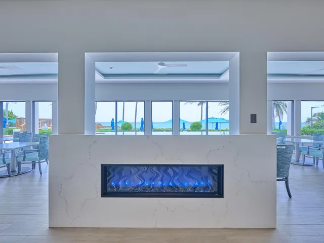 a dining room with furniture water view and wooden floor