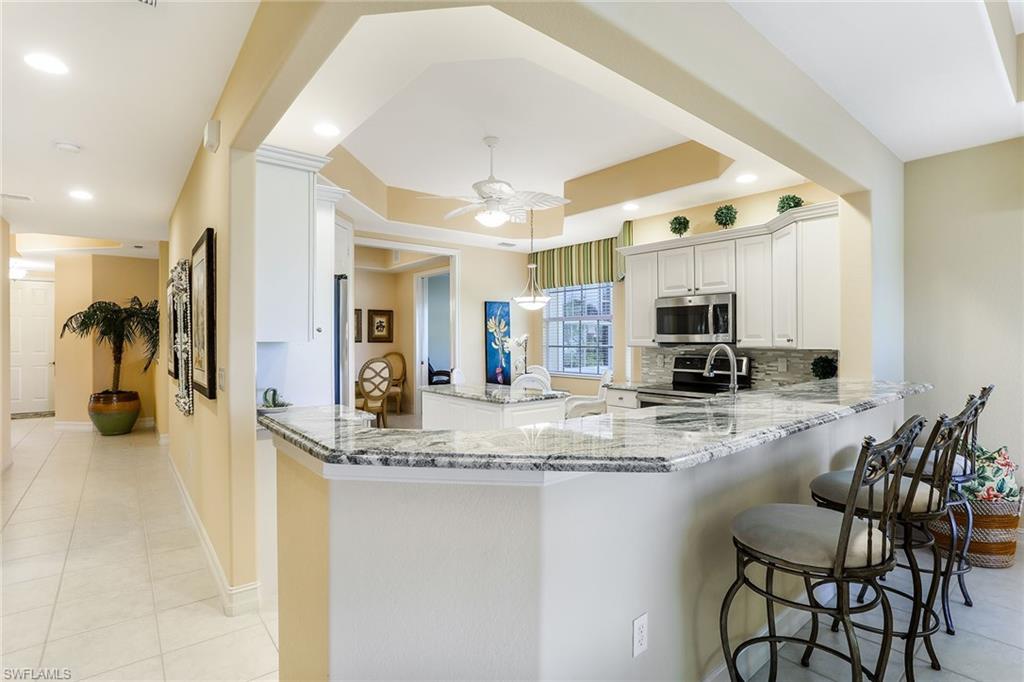 8609 Champions Point, Unit 201 Naples, FL 34113 - Photo 11 of 25 a view of kitchen with sink and refrigerator