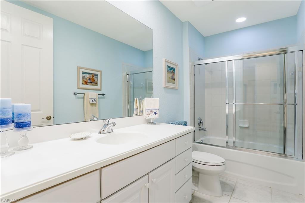 8609 Champions Point, Unit 201 Naples, FL 34113 - Photo 12 of 25 a bathroom with a sink toilet and shower