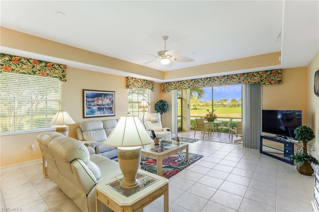 8609 Champions Point, Unit 201 Naples, FL 34113 - Photo 19 of 25 a living room with fireplace furniture and a flat screen tv