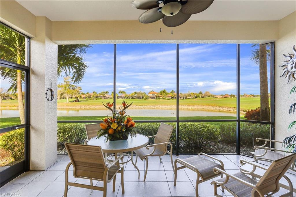 8609 Champions Point, Unit 201 Naples, FL 34113 - Photo 22 of 25 a view of a dining table and chairs in the patio