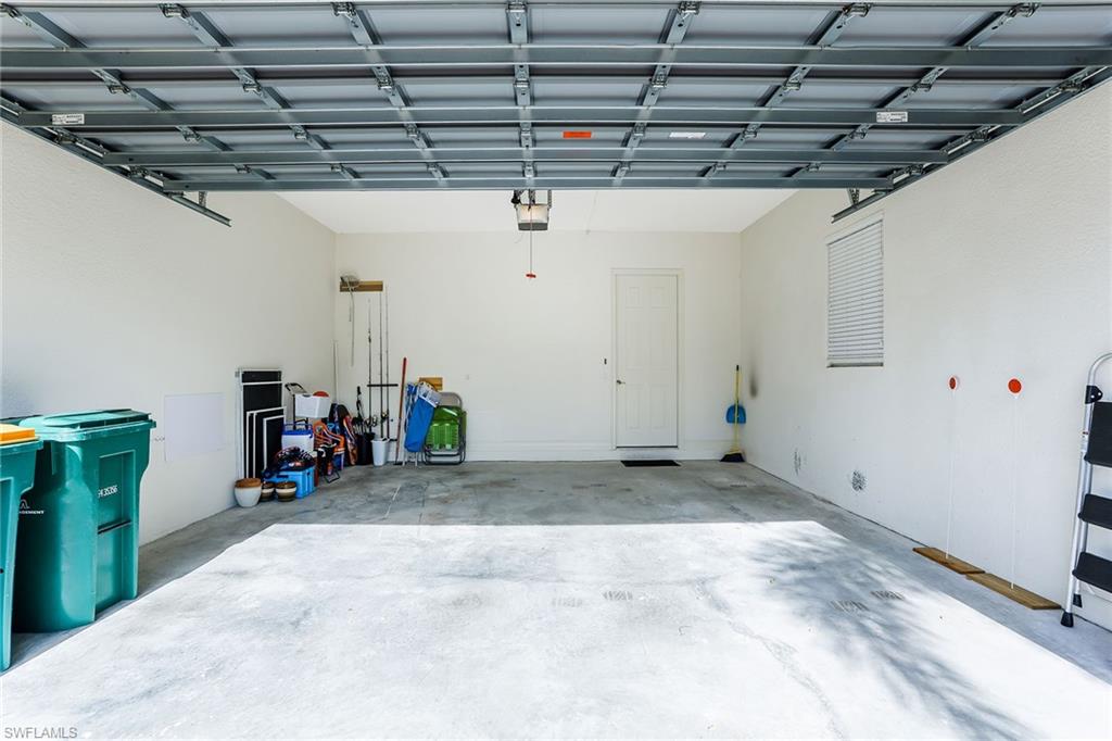 8609 Champions Point, Unit 201 Naples, FL 34113 - Photo 23 of 25 a view of a garage with storage