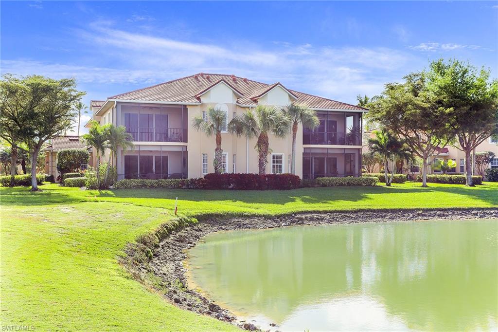 8609 Champions Point, Unit 201 Naples, FL 34113 - Photo 25 of 25 a front view of a house with swimming pool and yard
