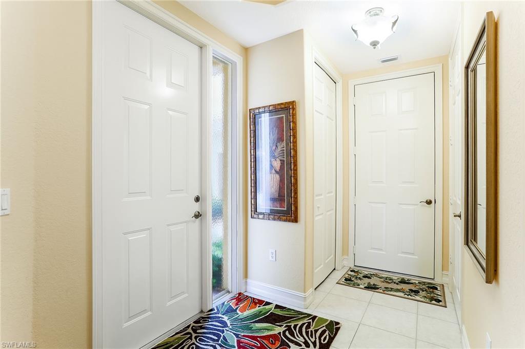 8609 Champions Point, Unit 201 Naples, FL 34113 - Photo 3 of 25 a view of room with walk in closet and wooden floor