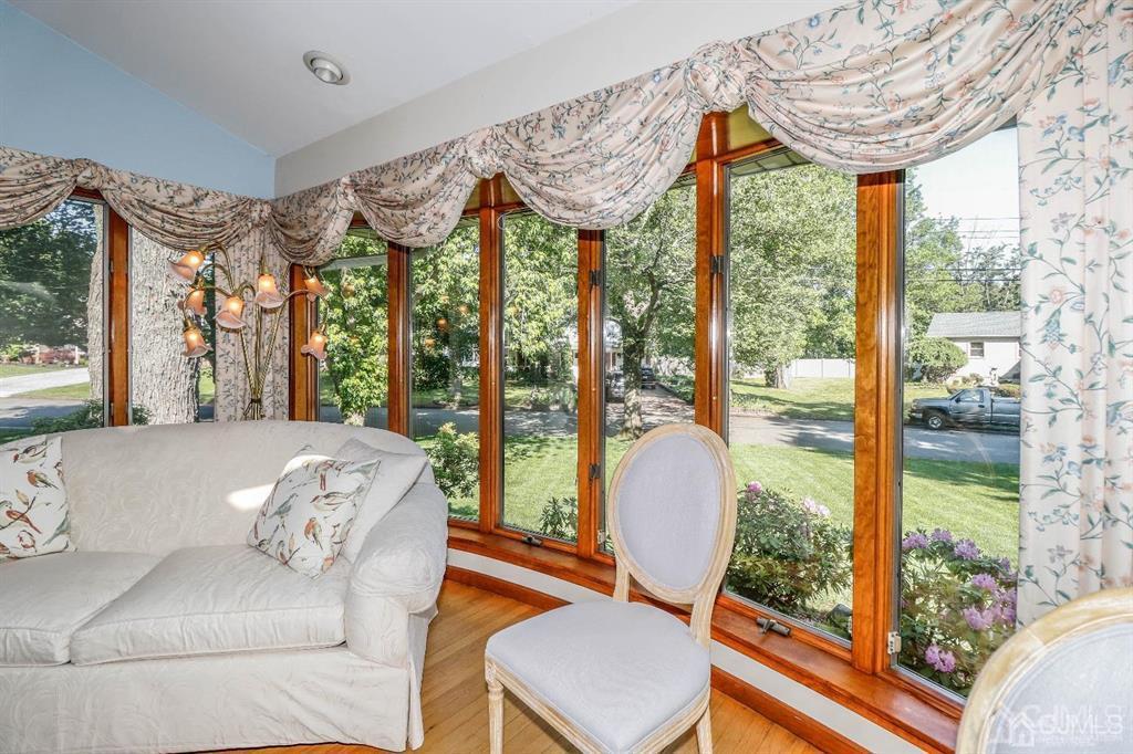 164 Devon Road Colonia, NJ 07067 - Photo 11 of 42 a living room with furniture and a floor to ceiling window