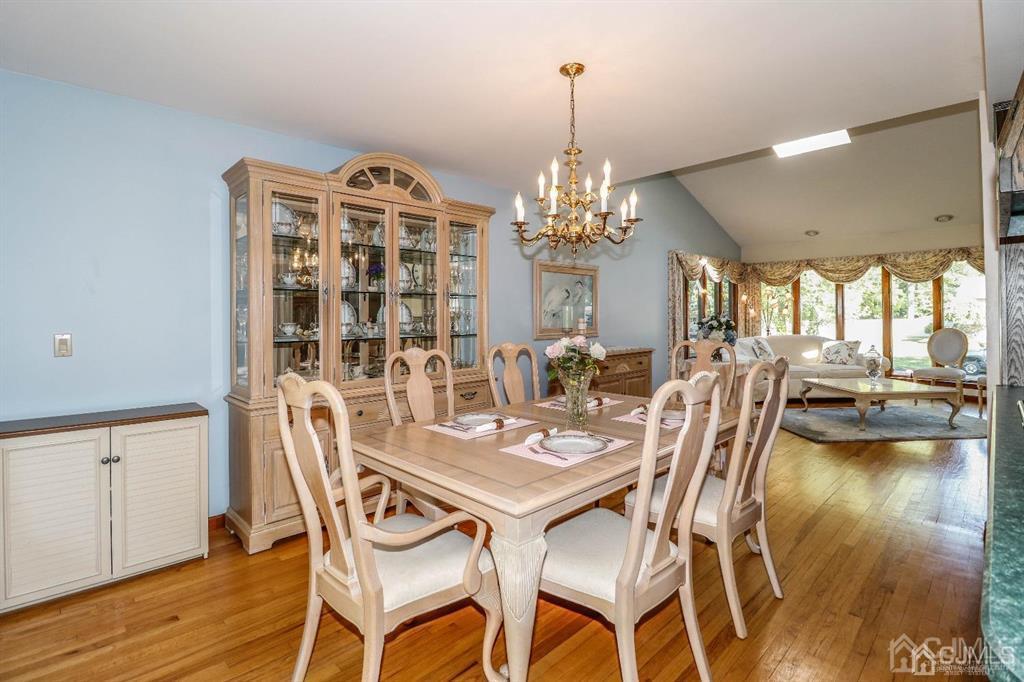 164 Devon Road Colonia, NJ 07067 - Photo 13 of 42 a view of a dining room with furniture and chandelier