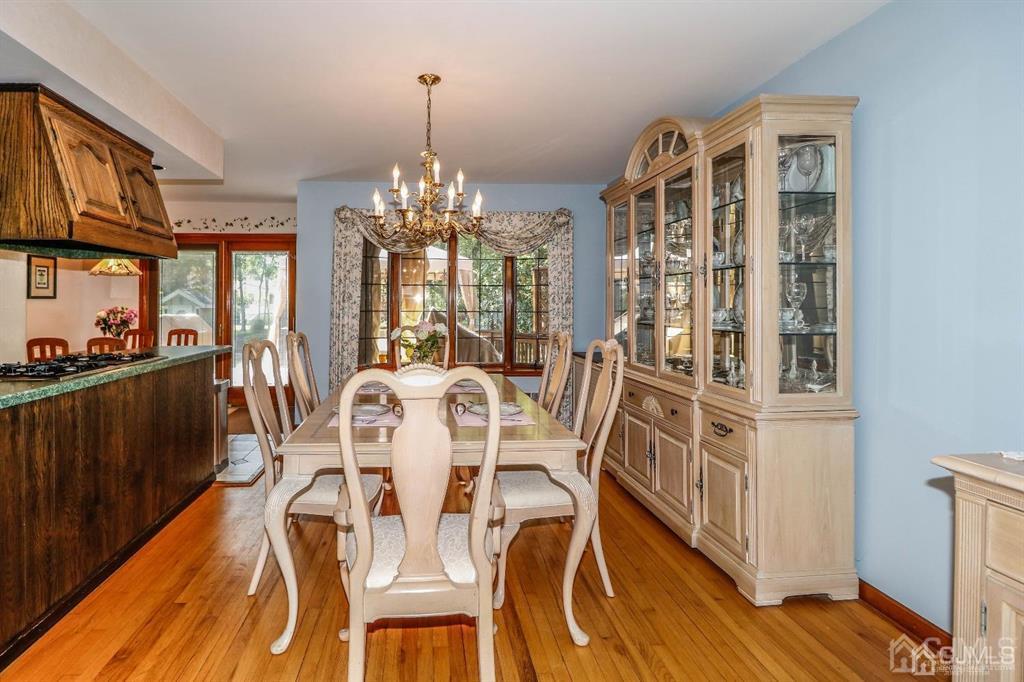 164 Devon Road Colonia, NJ 07067 - Photo 14 of 42 a view of a dining room with furniture and wooden floor