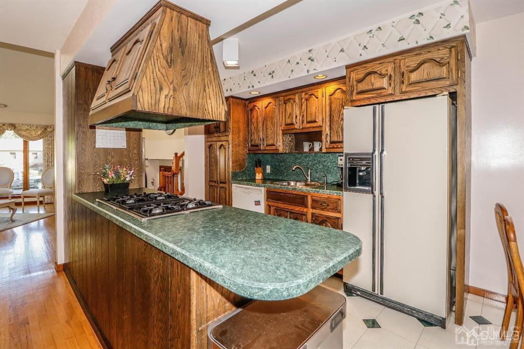 164 Devon Road Colonia, NJ 07067 - Photo 15 of 42 a kitchen with stainless steel appliances granite countertop a sink and a refrigerator