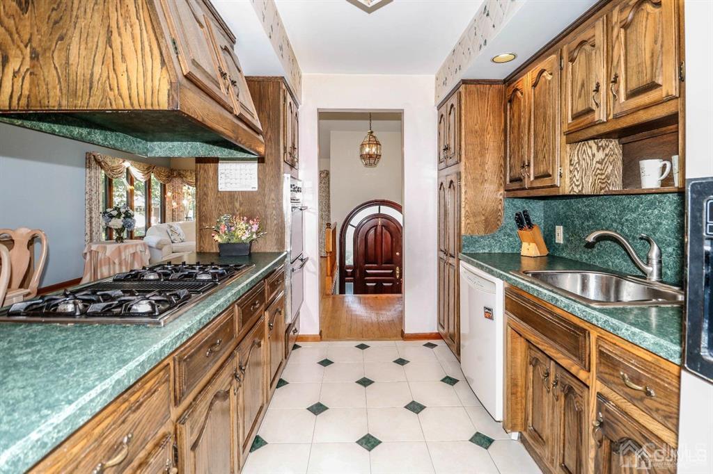 164 Devon Road Colonia, NJ 07067 - Photo 16 of 42 a kitchen with stainless steel appliances granite countertop a stove and a sink