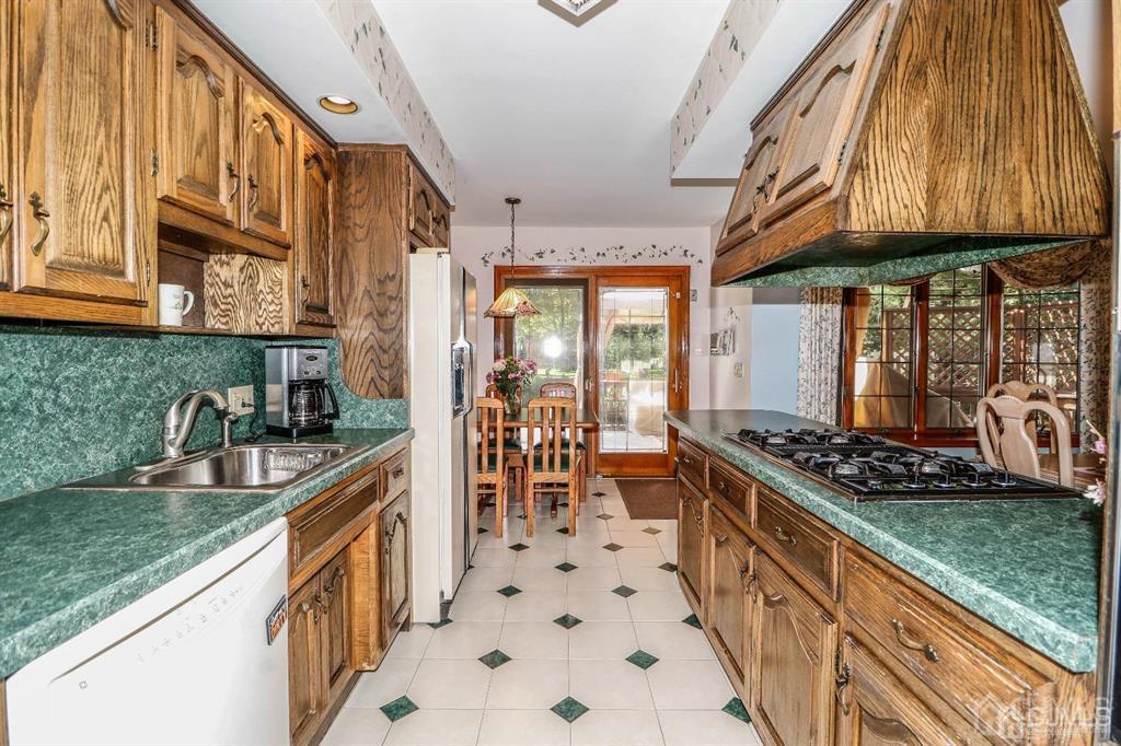 164 Devon Road Colonia, NJ 07067 - Photo 18 of 42 a kitchen with stainless steel appliances granite countertop a stove and a sink