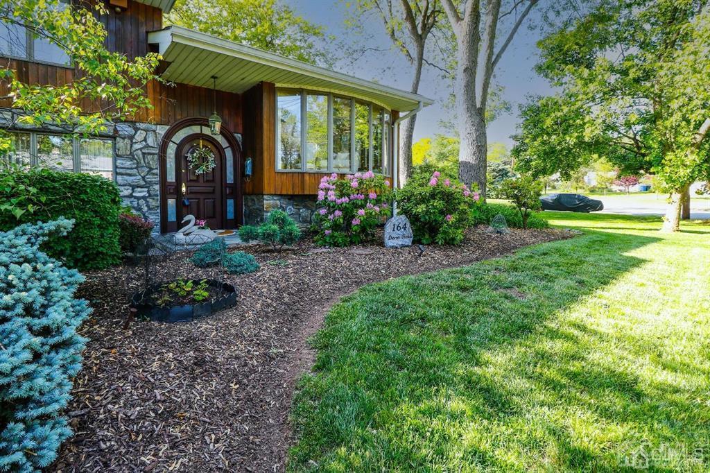 164 Devon Road Colonia, NJ 07067 - Photo 2 of 42 a front view of a house with garden