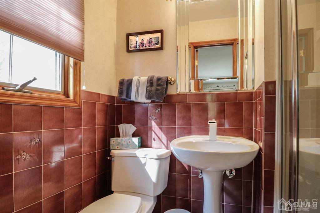 164 Devon Road Colonia, NJ 07067 - Photo 21 of 42 a bathroom with a sink a toilet and mirror