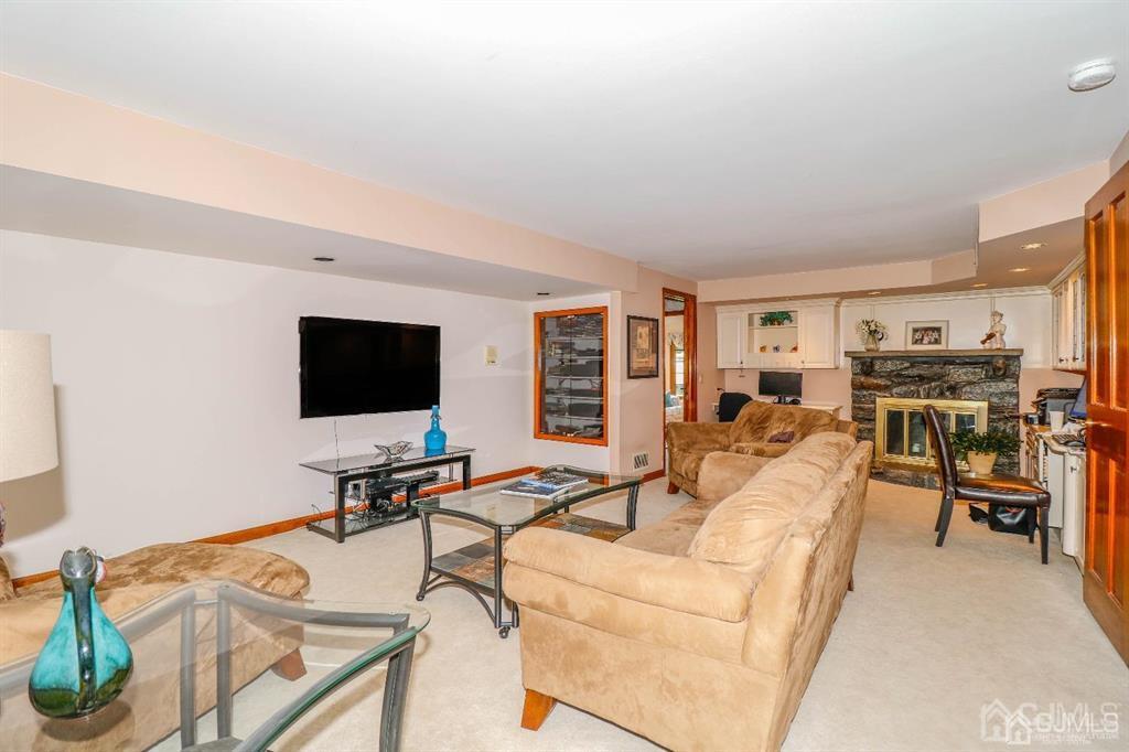 164 Devon Road Colonia, NJ 07067 - Photo 22 of 42 a living room with furniture and a flat screen tv