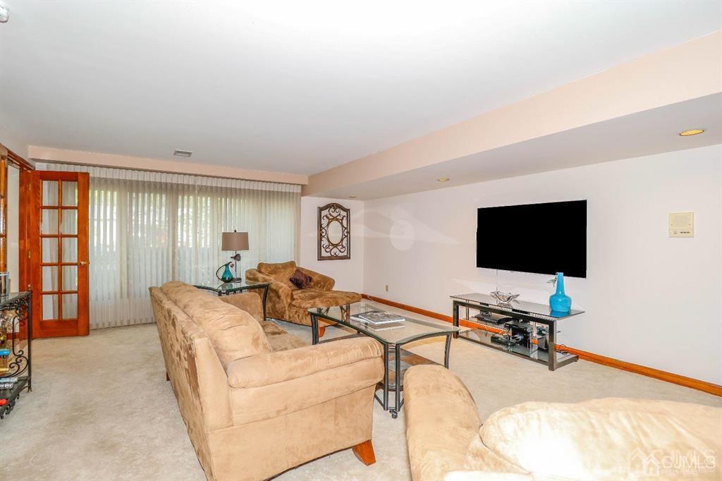 164 Devon Road Colonia, NJ 07067 - Photo 23 of 42 a living room with furniture and a flat screen tv