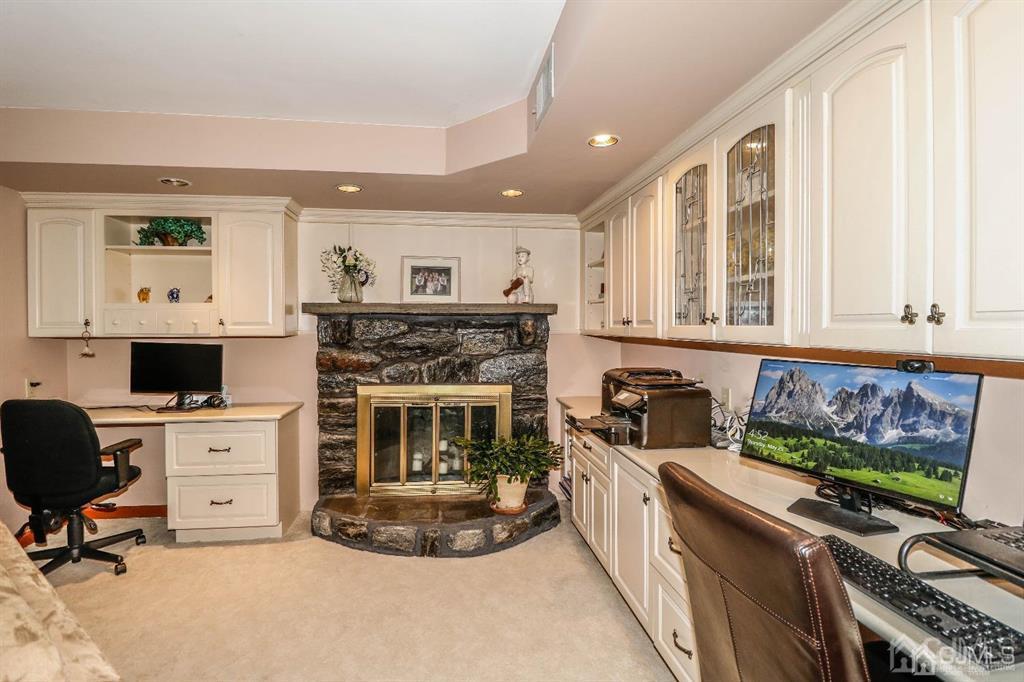 164 Devon Road Colonia, NJ 07067 - Photo 25 of 42 a living room with furniture and a fireplace