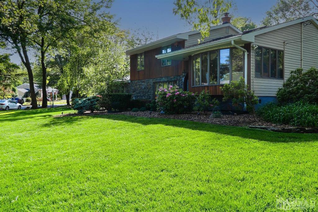 164 Devon Road Colonia, NJ 07067 - Photo 3 of 42 a front view of a house with garden