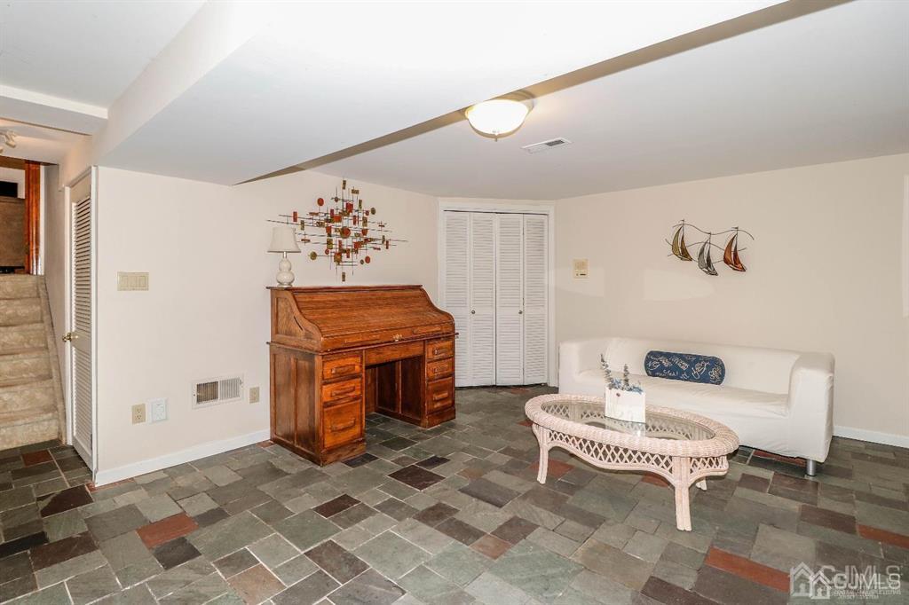 164 Devon Road Colonia, NJ 07067 - Photo 32 of 42 a living room with furniture and a table