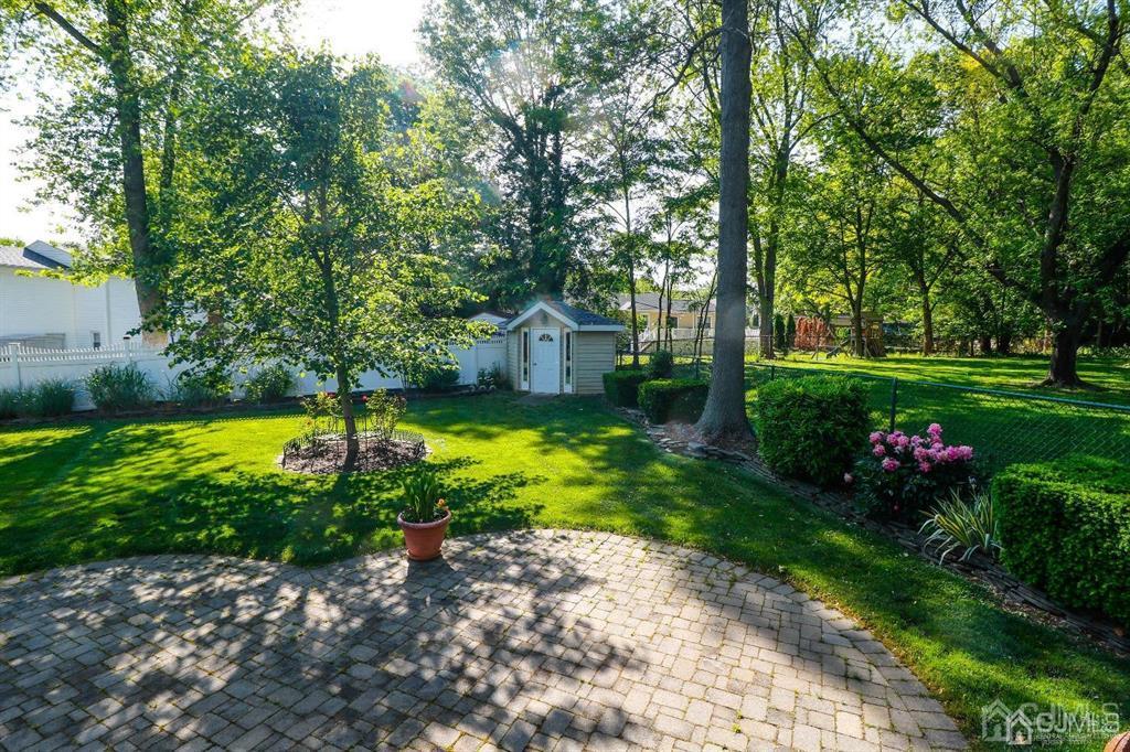 164 Devon Road Colonia, NJ 07067 - Photo 36 of 42 a view of a garden with plants and large trees